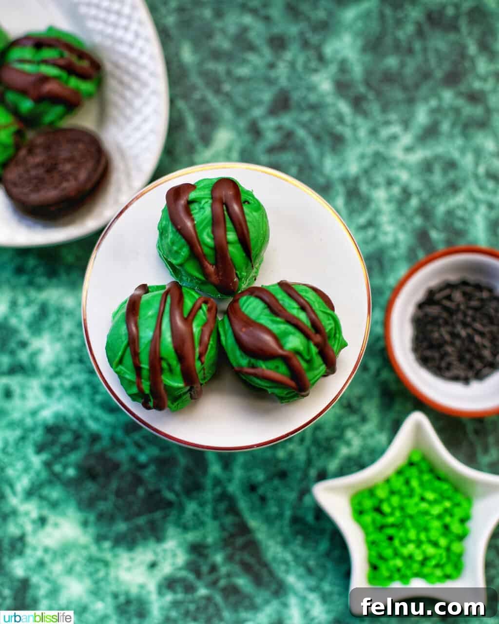 Mint Oreo Bliss Bites 6 Mint Oreo Truffles on a plate with sprinkles.