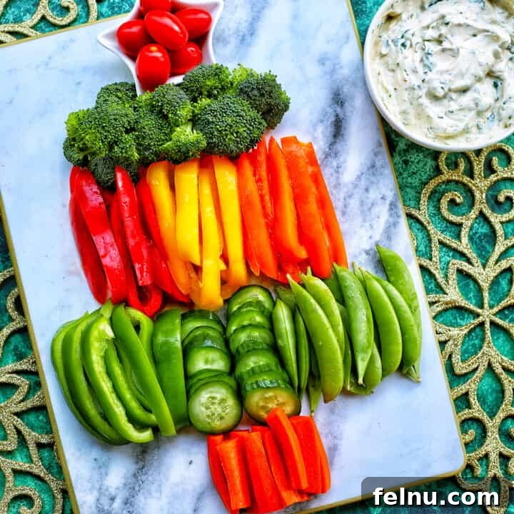Christmas Tree Vegetable Platter 13 christmas tree veggie tray with bell pepper slices, broccoli, cucumbers, and carrots.