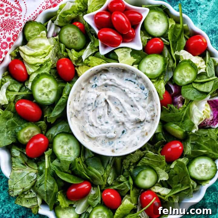 Christmas wreath salad with lettuce, cucumbers, and tomatoes