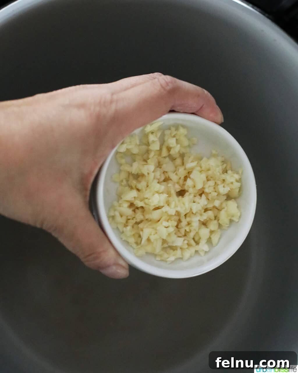 Flavorful Instant Pot Garlic Rice 6 adding minced garlic to instant pot