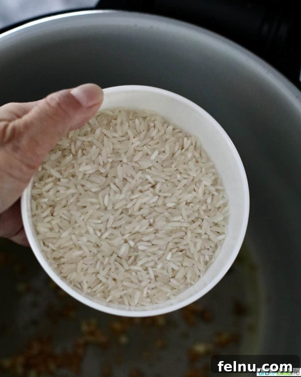 Flavorful Instant Pot Garlic Rice 8 adding rice to the instant pot