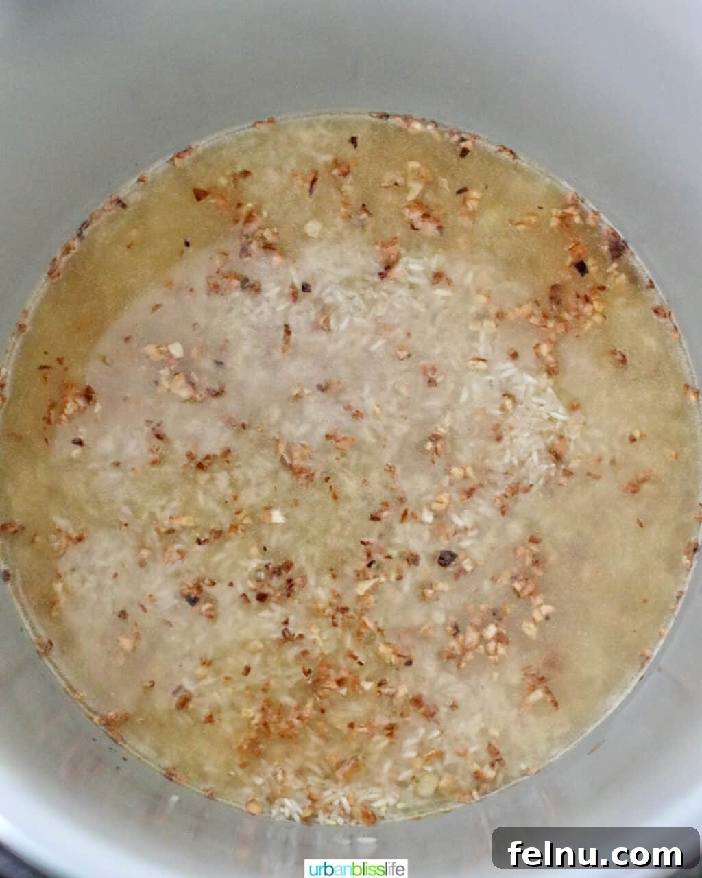 Flavorful Instant Pot Garlic Rice 9 chicken broth over rice in instant pot