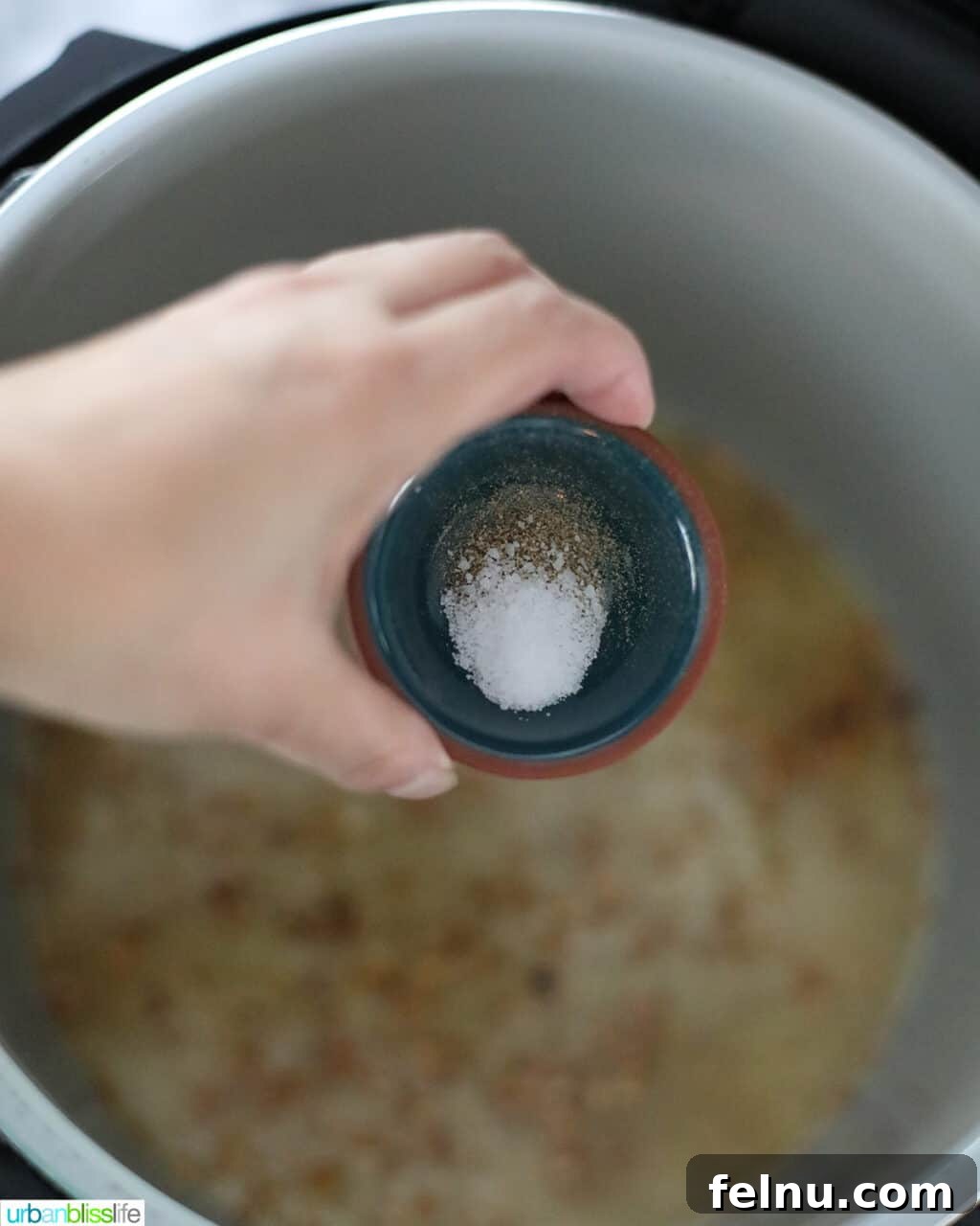 Flavorful Instant Pot Garlic Rice 10 adding salt and pepper to instant pot