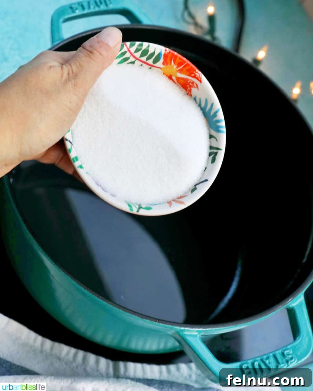Effortless Simple Syrup: Sweeten Anything 7 Adding granulated sugar to the pot of water, preparing to combine the two simple syrup ingredients.
