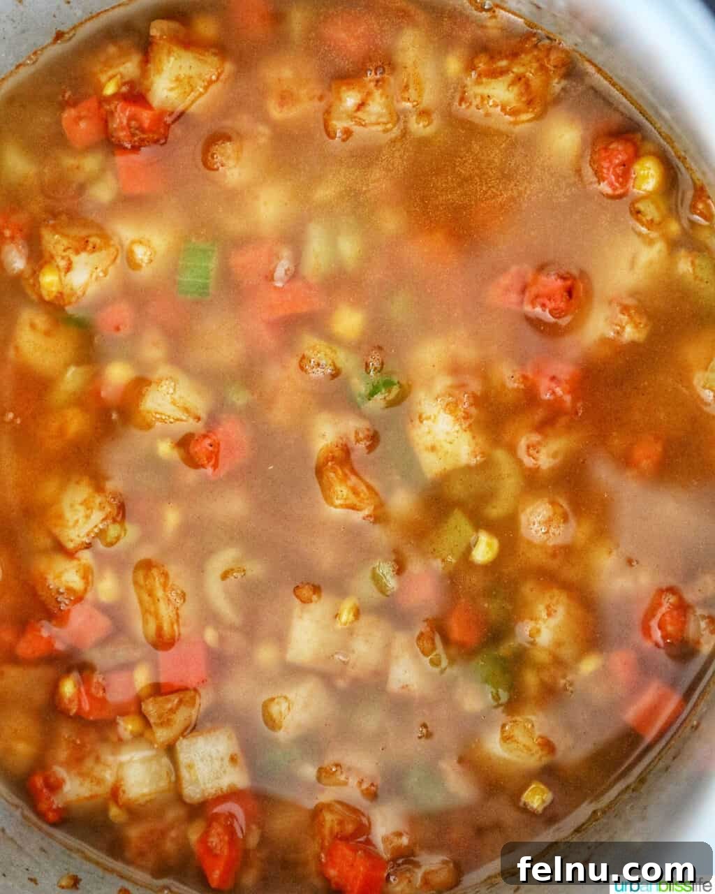 Creamy Potato Corn Chowder Made Easy 12 Broth covering the vegetables in the Instant Pot