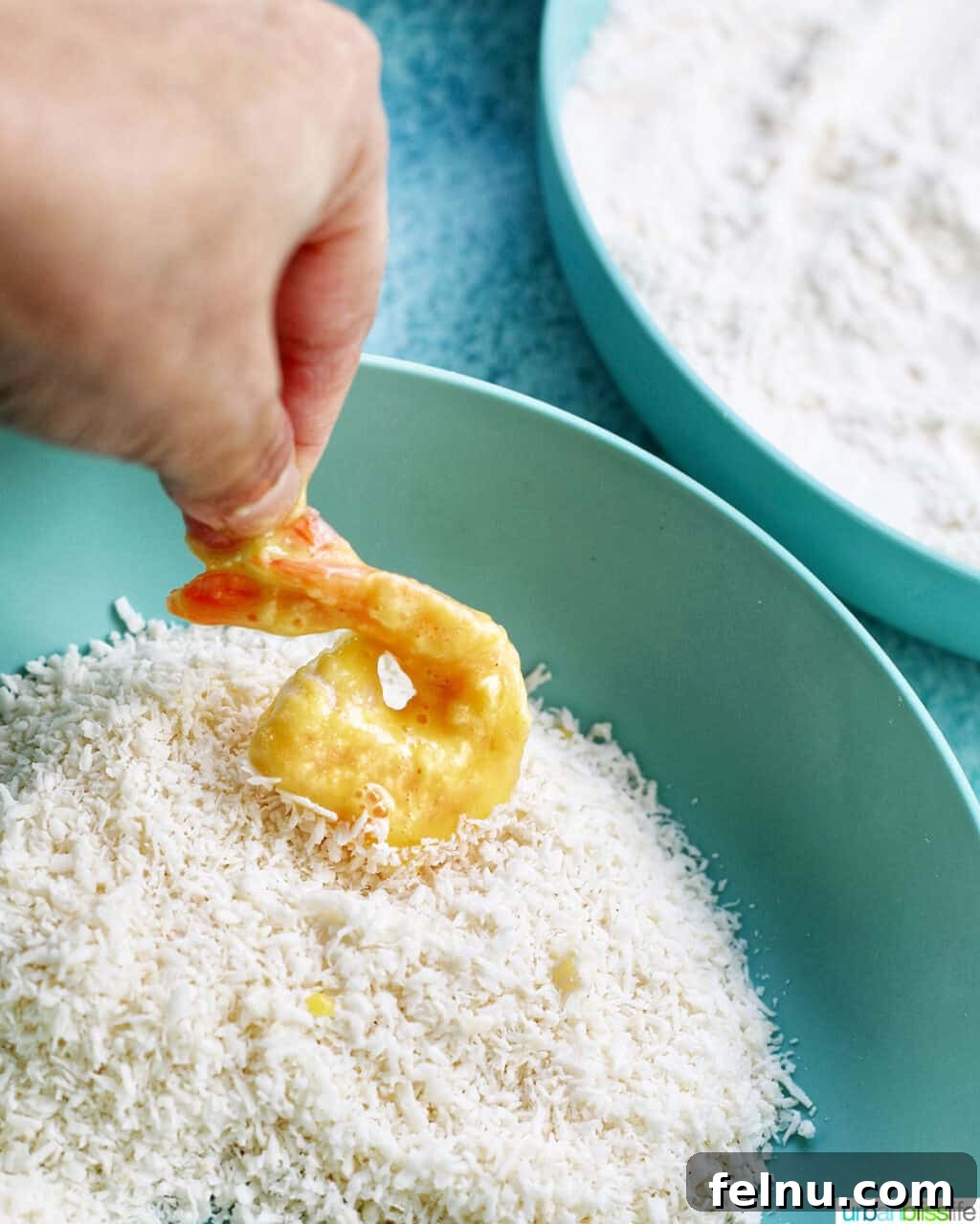 Crispy Gluten-Free Air Fryer Coconut Shrimp 11 dredging shrimp in shredded coconut for coconut shrimp