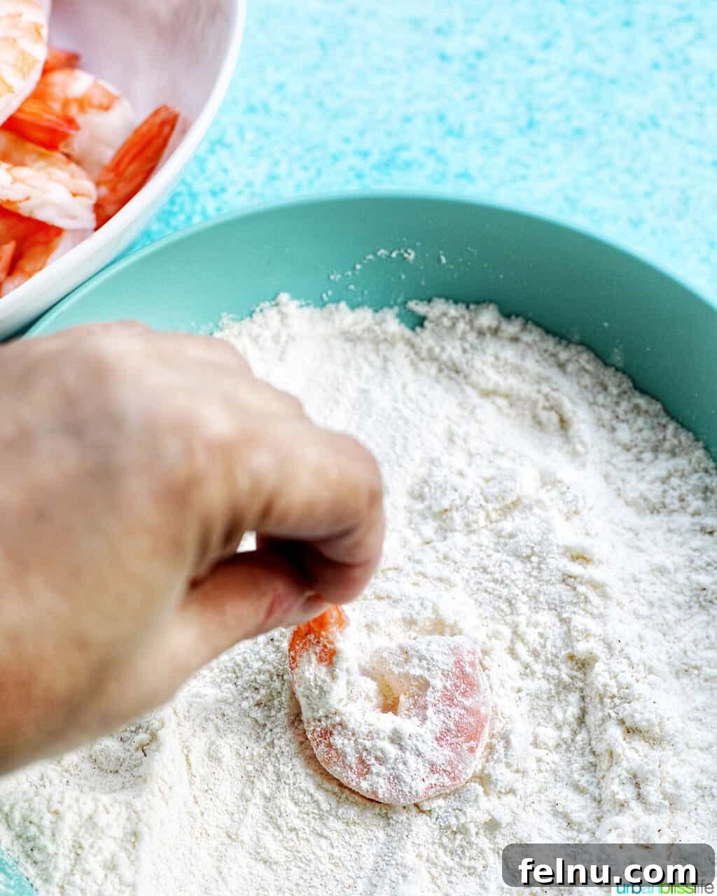 Crispy Gluten-Free Air Fryer Coconut Shrimp 9 dredging shrimp in flour mixture