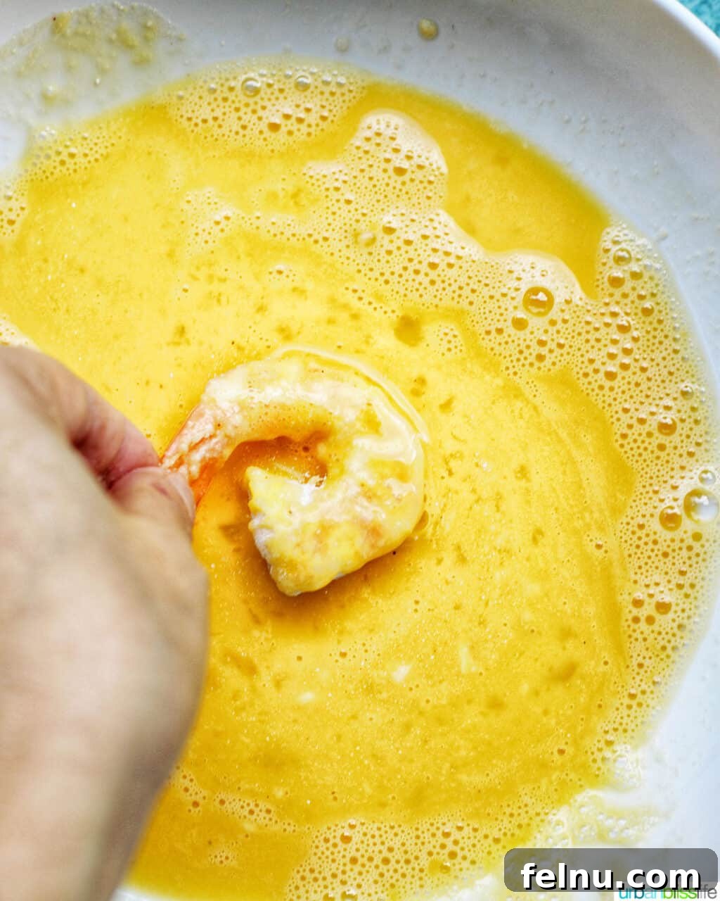 Crispy Gluten-Free Air Fryer Coconut Shrimp 10 dredging shrimp in egg for coconut shrimp
