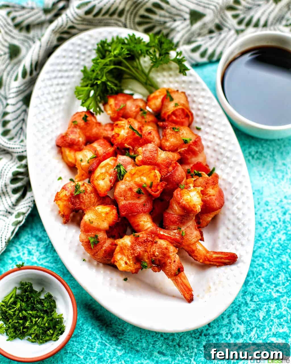 Air Fryer Bacon Shrimp Skewers 13 Air fryer bacon wrapped shrimp on a white plate