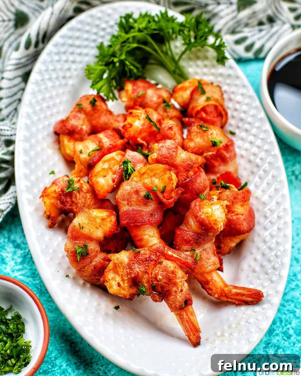 Air Fryer Bacon Shrimp Skewers 3 Air fryer bacon wrapped shrimp on a white plate