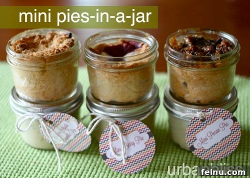 A selection of mini berry, pecan, and apple pies in jars, perfect for gifting or individual desserts.