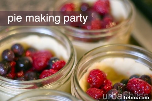Colorful mini berry pies in jars with golden crusts.