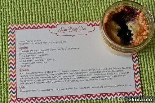 Overhead shot of mini berry pies in jars cooling on a rack.
