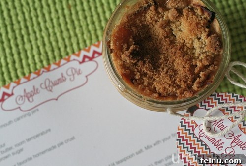 Mini apple crumb pies in jars, fresh from the oven, with steam gently rising.