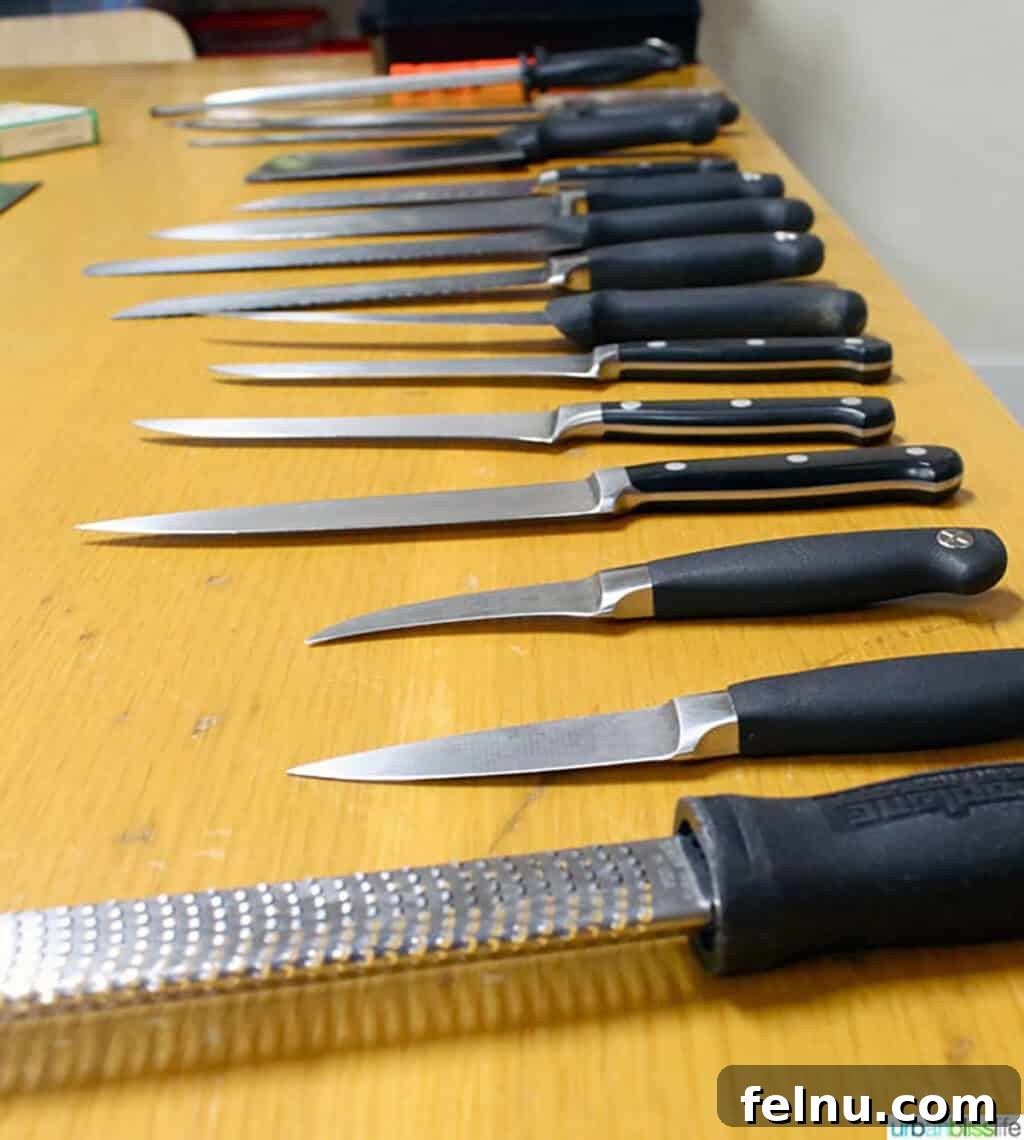 Sharpen Your Skills: The Definitive Guide to Kitchen Knives 2 A collection of essential kitchen knives displayed on a table, highlighting the variety discussed in this guide.