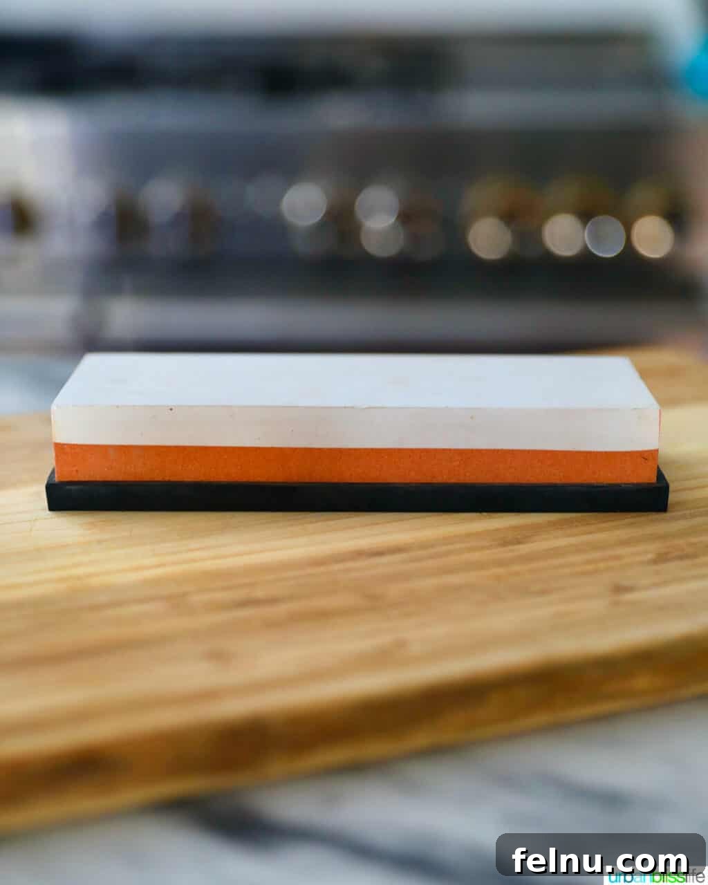 Sharpen Your Skills: The Definitive Guide to Kitchen Knives 11 A high-quality whetstone, showing its dual-sided grit texture, ready for manual knife sharpening.