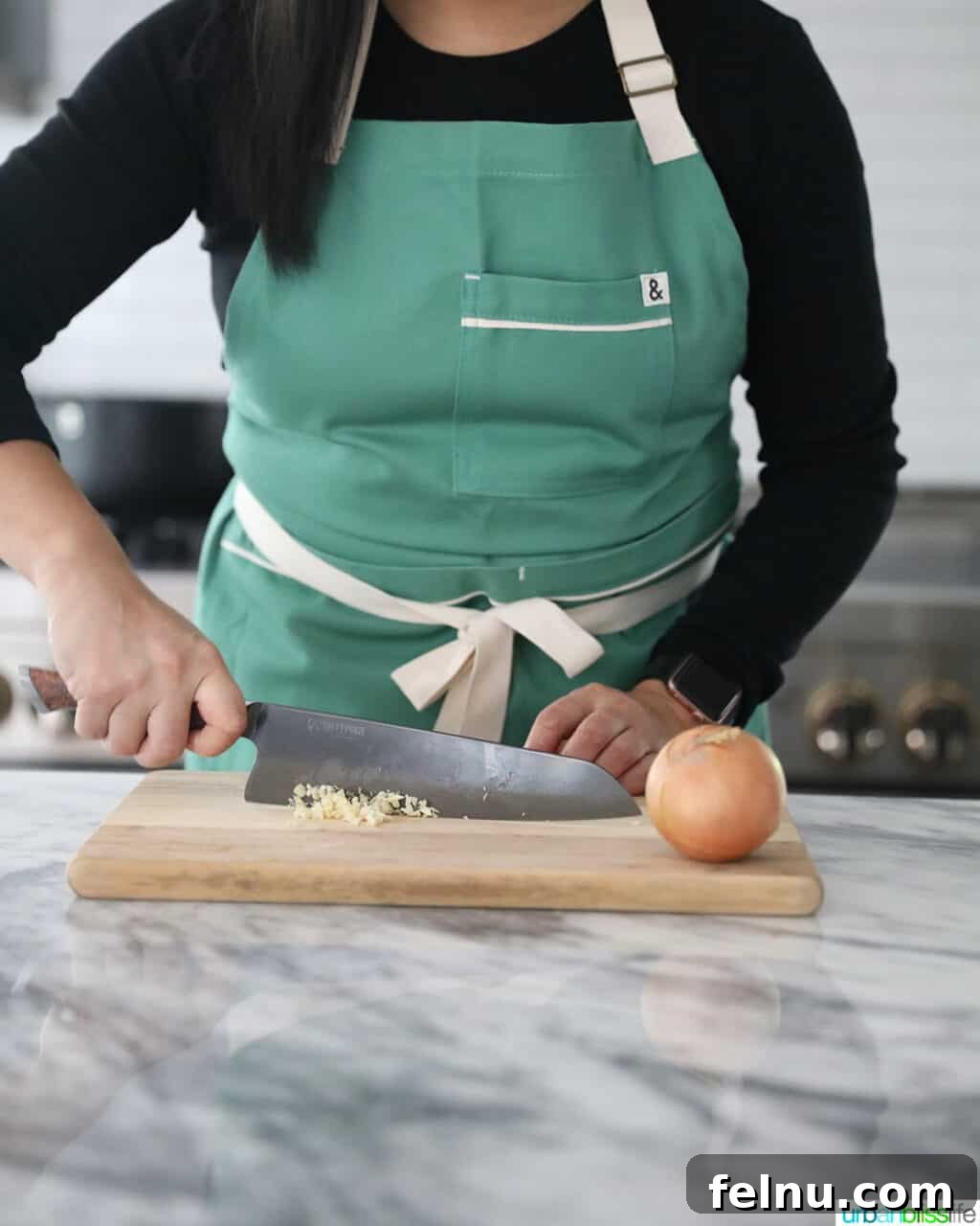 Sharpen Your Skills: The Definitive Guide to Kitchen Knives 12 A high-carbon steel chef's knife in action, meticulously chopping garlic and onions, showcasing its precision.