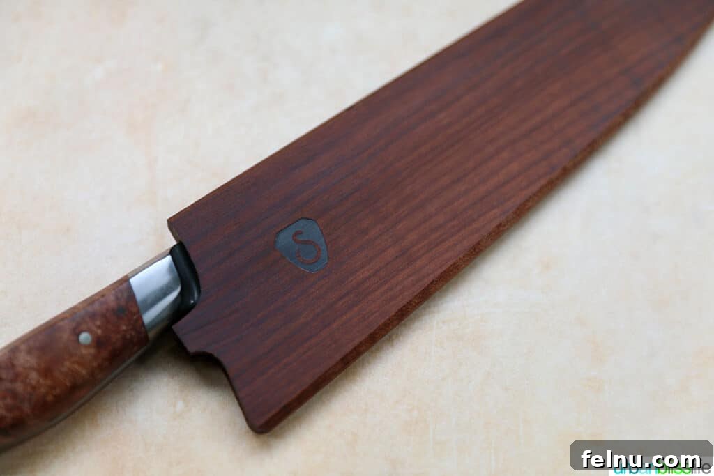 Sharpen Your Skills: The Definitive Guide to Kitchen Knives 14 A high-quality kitchen knife securely sheathed in a wooden knife guard, emphasizing safe and protective storage.