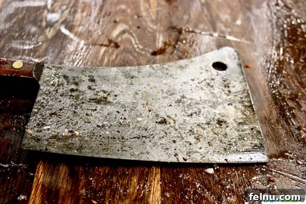 Sharpen Your Skills: The Definitive Guide to Kitchen Knives 9 A robust meat cleaver, hinting at its powerful utility for heavy-duty kitchen tasks, after being used in a butchery workshop.