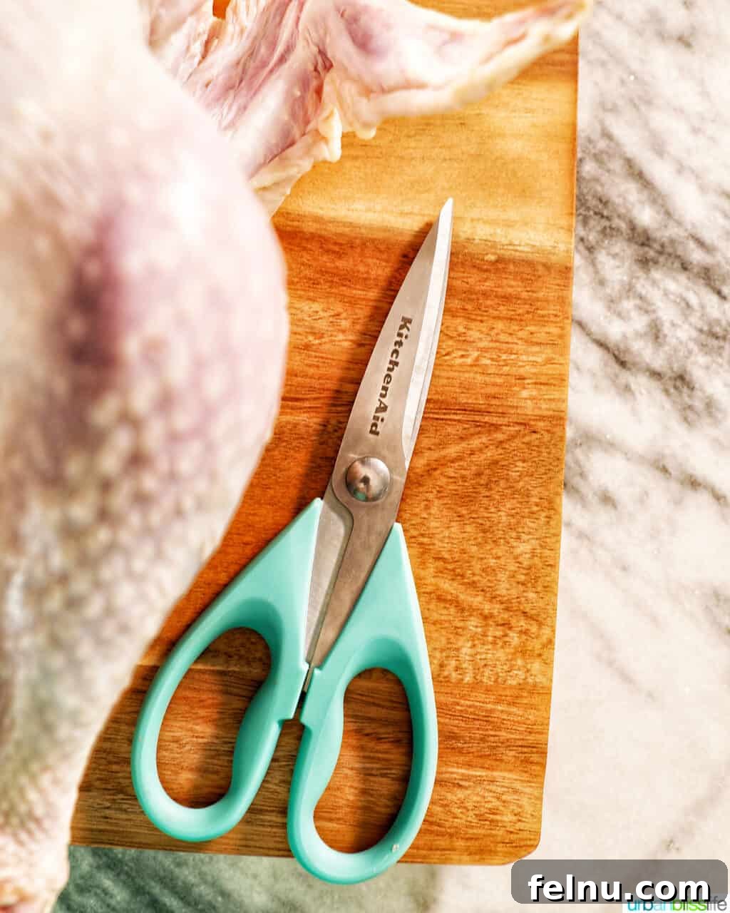 Sharpen Your Skills: The Definitive Guide to Kitchen Knives 10 Sharp kitchen shears expertly cutting through raw chicken, demonstrating their utility in poultry preparation.