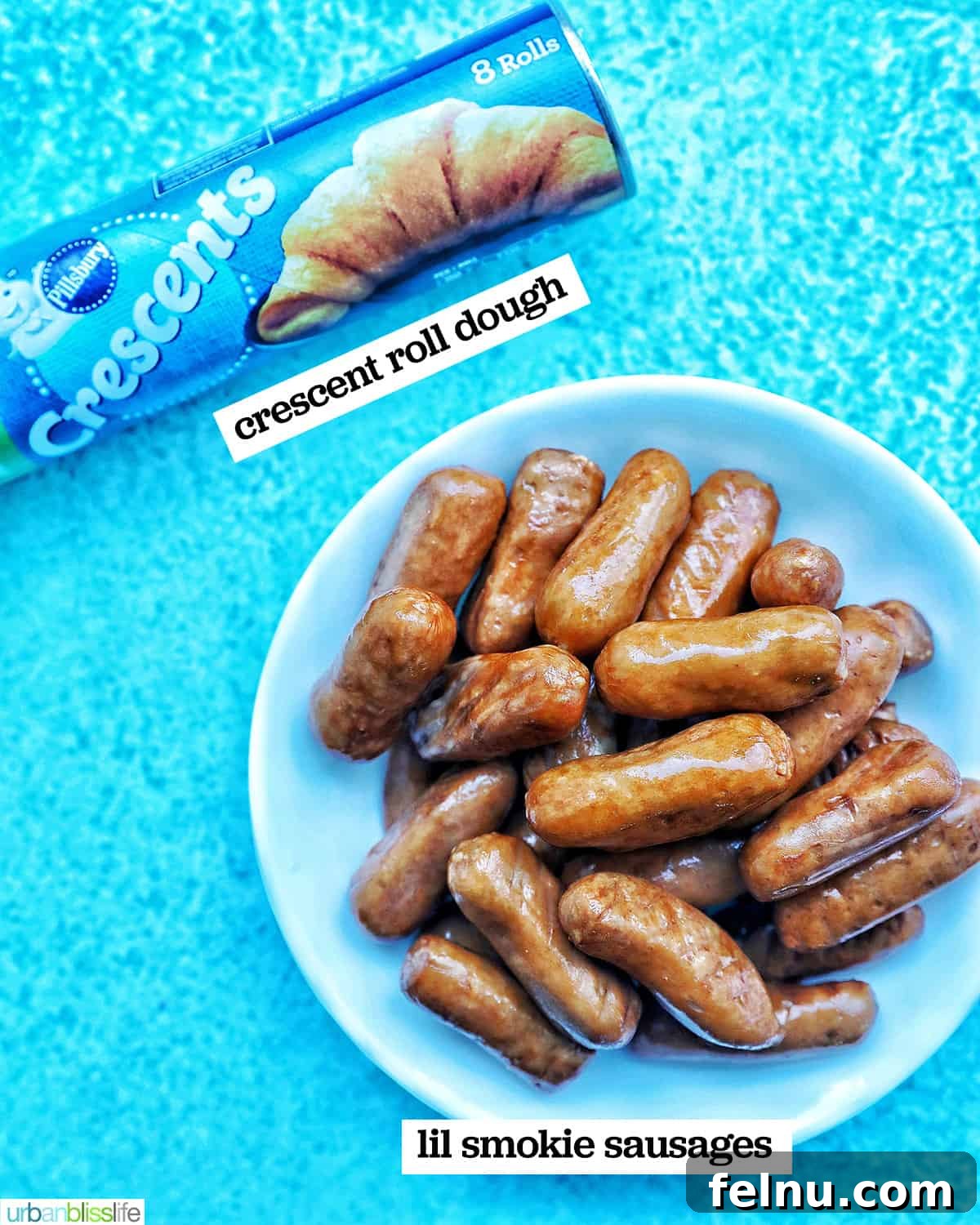 Crispy Air-Fried Pigs in a Blanket 4 2 ingredients to make Air Fryer Pigs in a Blanket on a bright blue background.