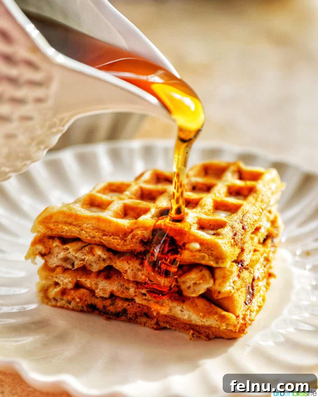 Banana Chocolate Chip Dream Waffles 17 Pouring syrup over a stack of Banana Chocolate Chip Waffles