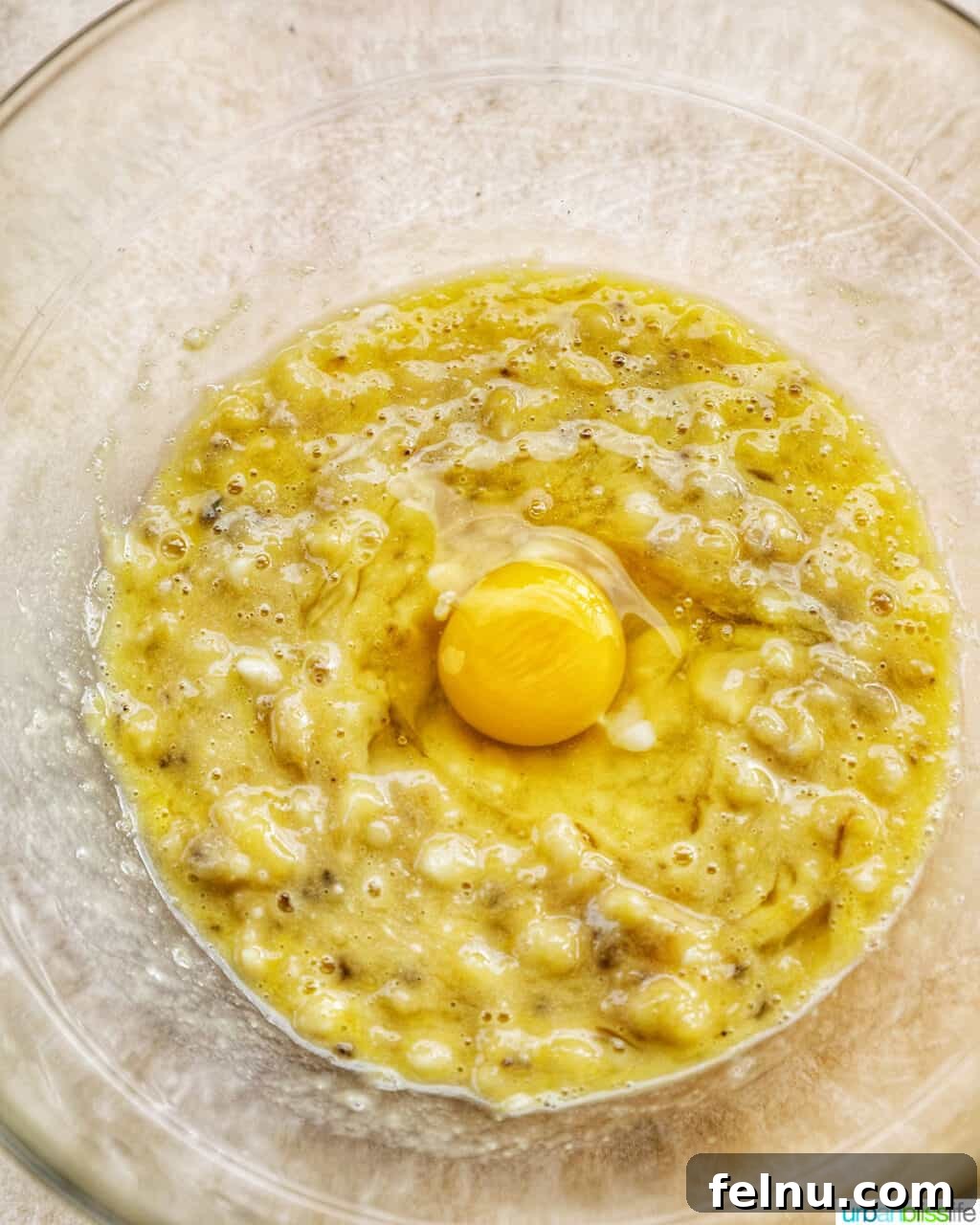 Banana Chocolate Chip Dream Waffles 8 Mixing an egg into the waffle batter
