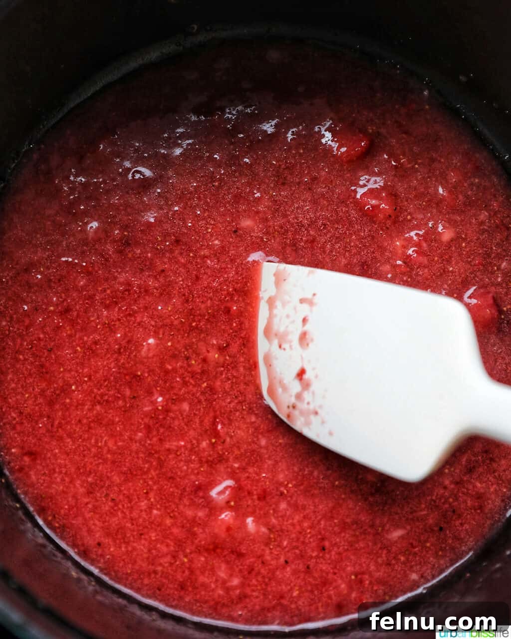 Stirring strawberries in a pot