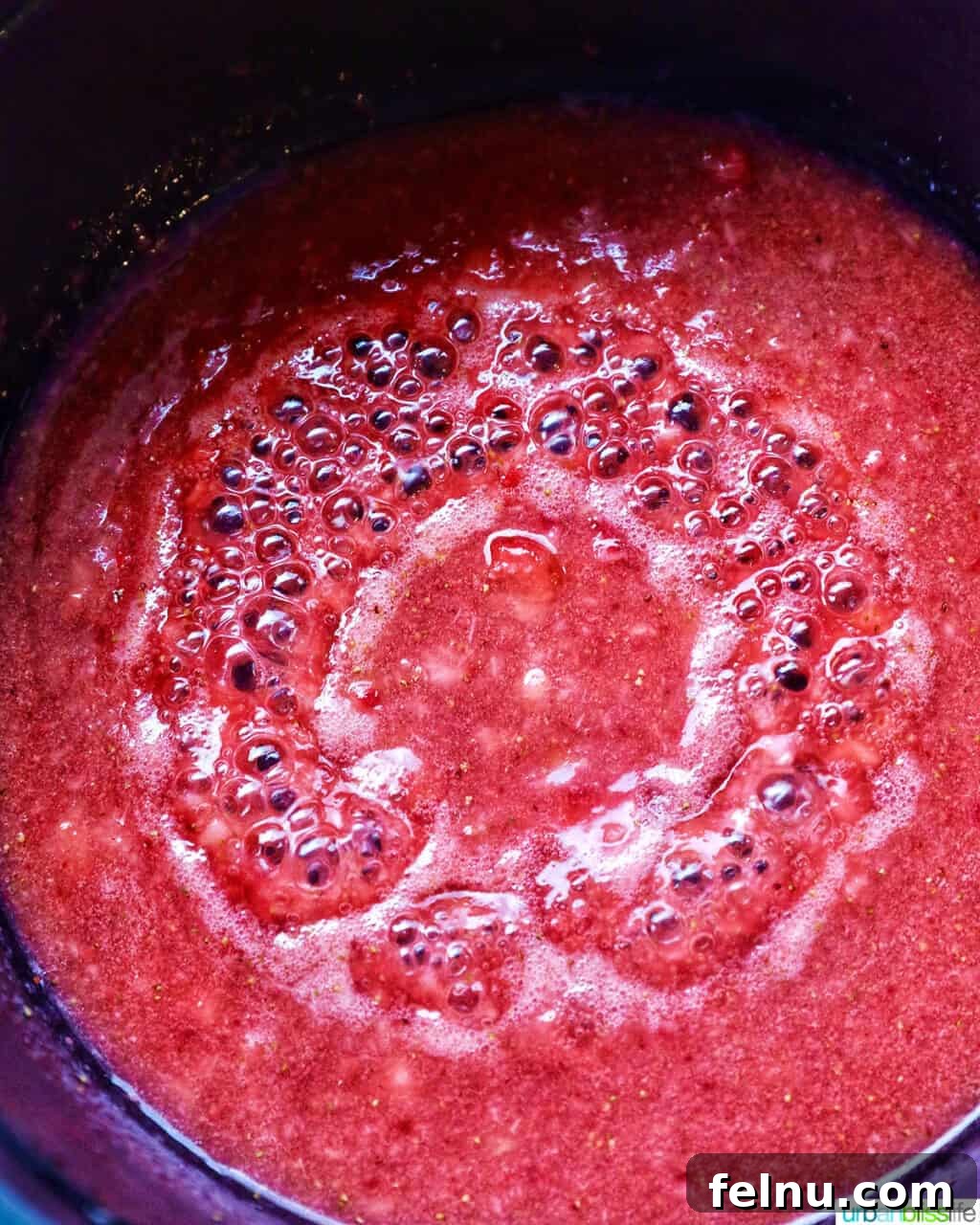 Strawberries boiling in a pan