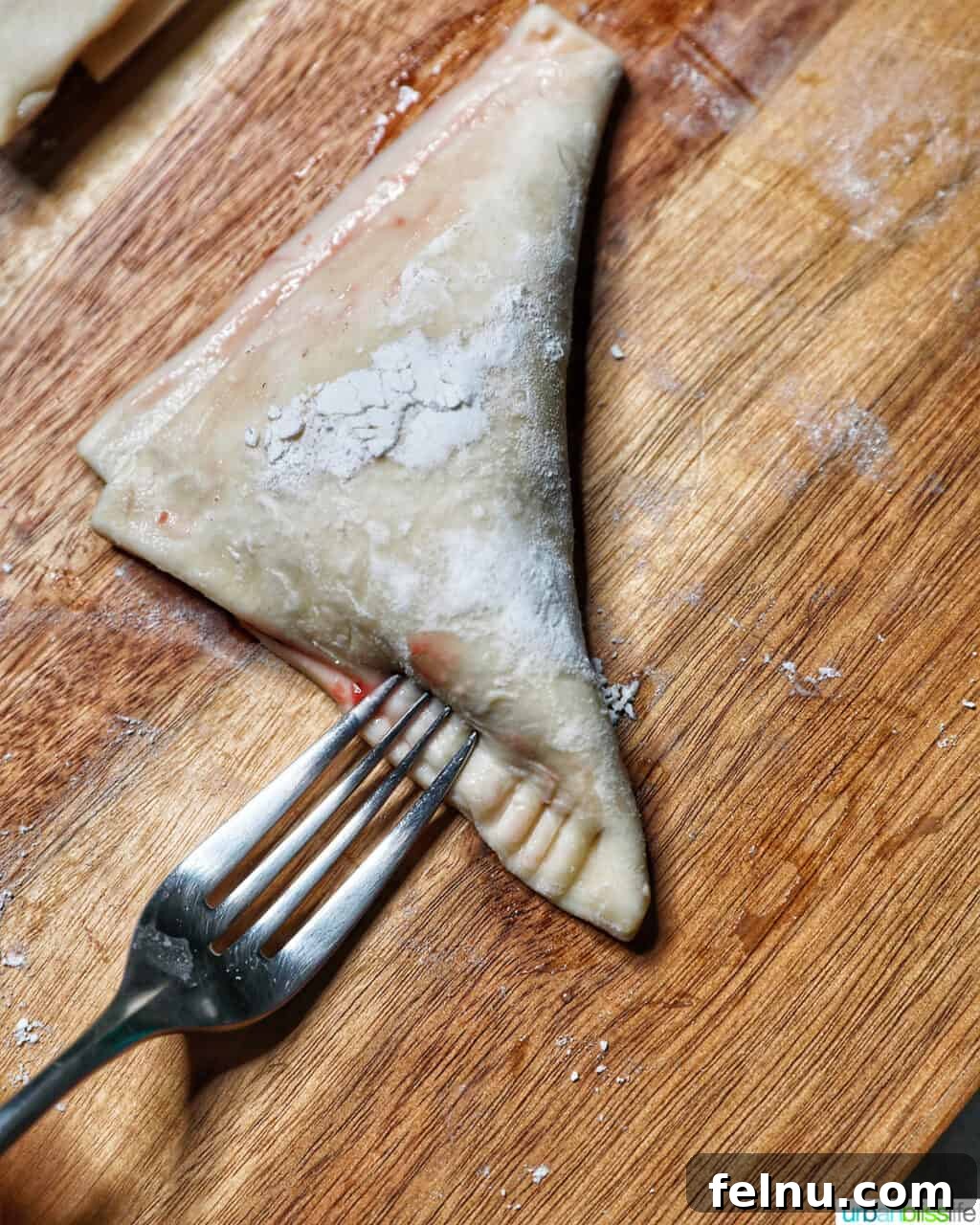 Flaky Strawberry Pockets 11 sealing edges of puff pastry with fork