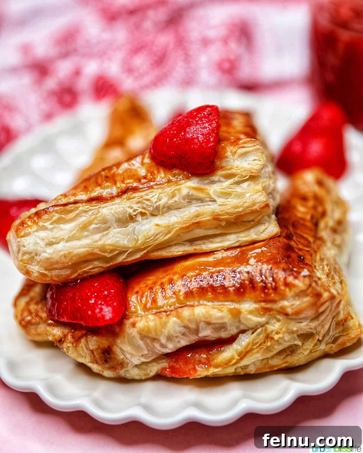 Flaky Strawberry Pockets 18 strawberry turnovers closeup stacked on plate