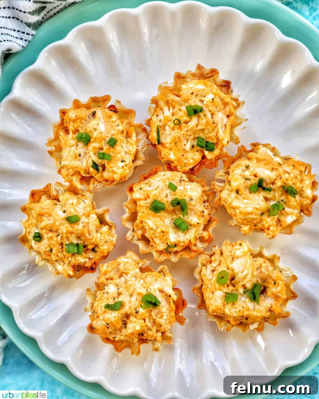 Kickin' Chicken Poppers 2 Crispy Buffalo Chicken Bites served on a plate, garnished with fresh chives.