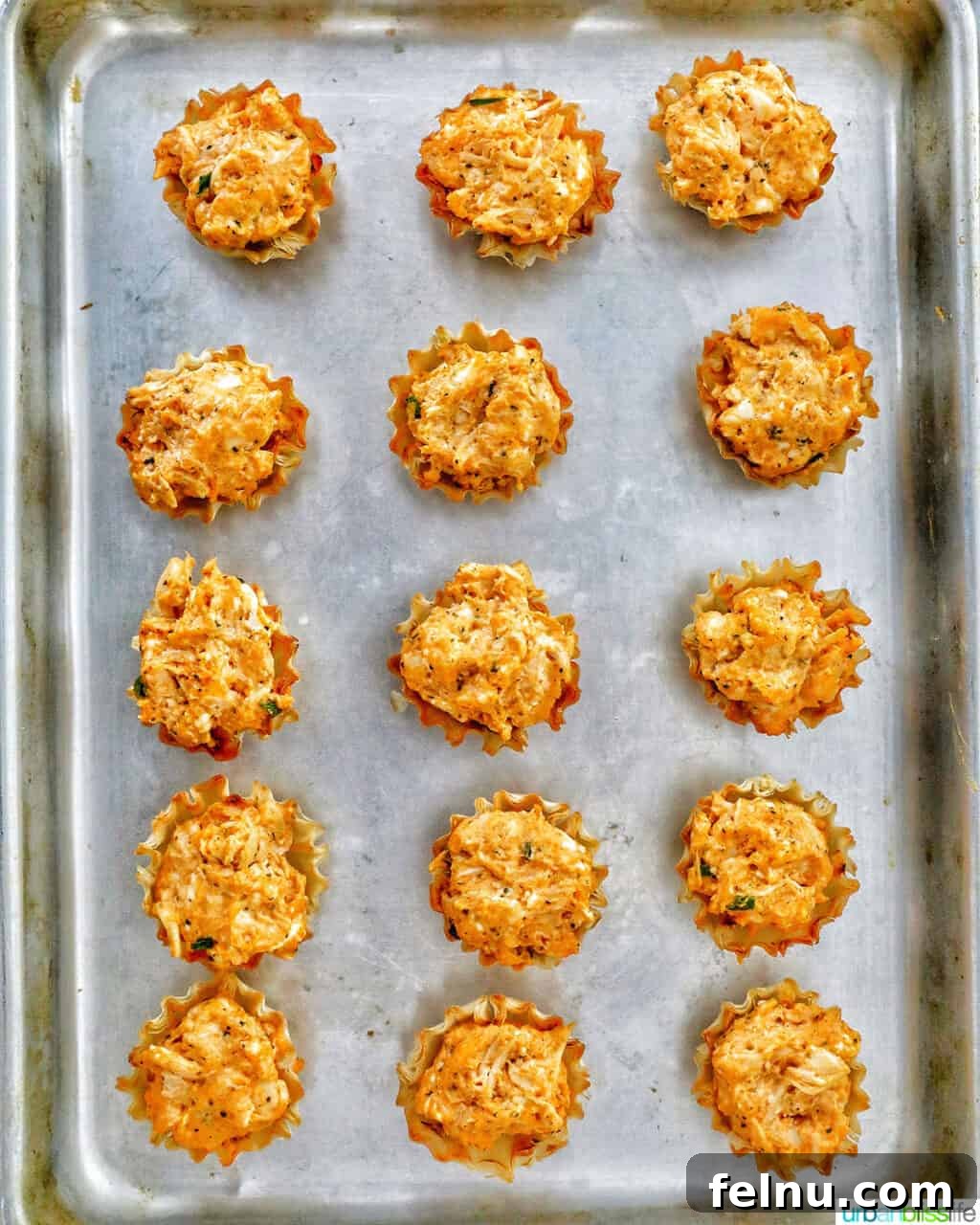 Spicy Buffalo Chicken Poppers 14 Freshly baked buffalo chicken bites in their crispy phyllo shells, golden and bubbling, straight from the oven.