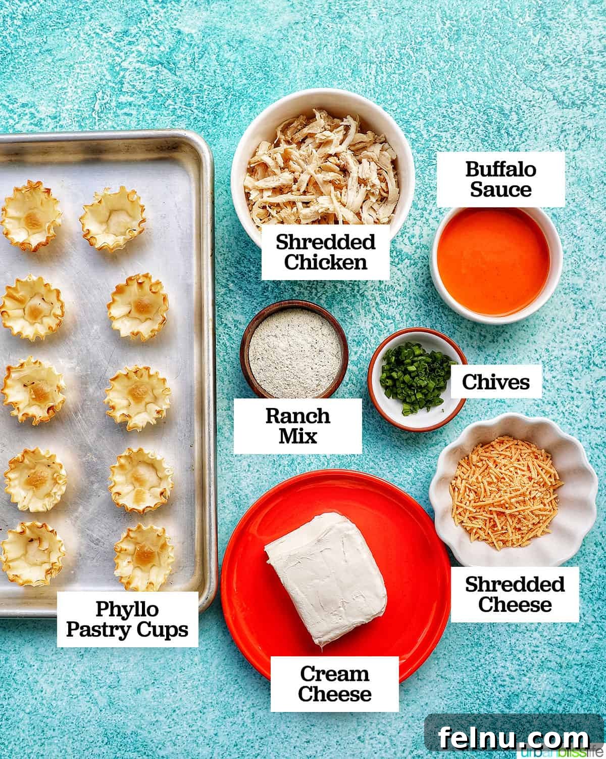 Spicy Buffalo Chicken Poppers 4 Bowls filled with key ingredients like shredded chicken, cream cheese, cheddar, buffalo sauce, and chives, ready for mixing on a bright blue background.