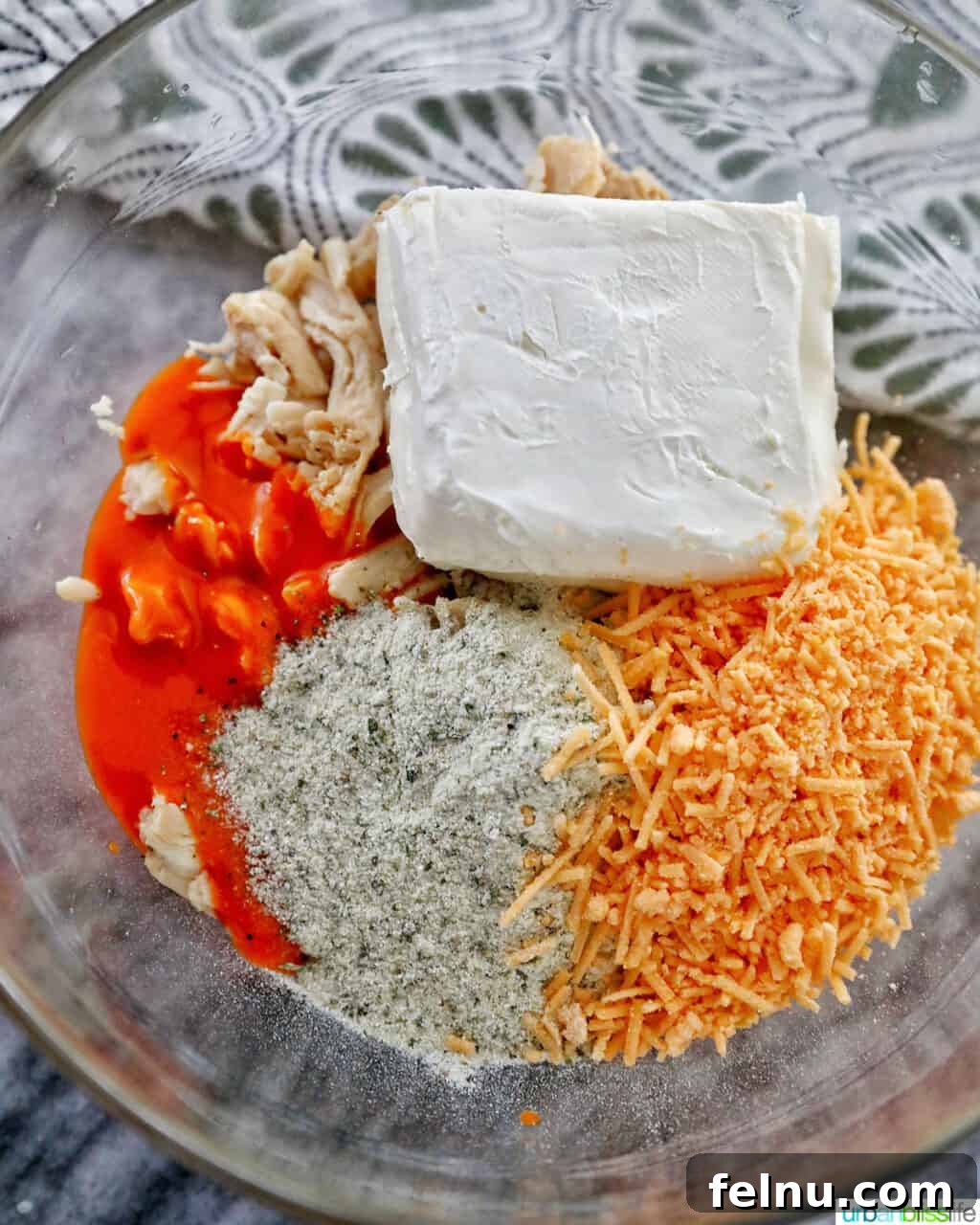 Kickin' Chicken Poppers 7 All ingredients (chicken, cheese, sauce, ranch mix) placed in a large mixing bowl.