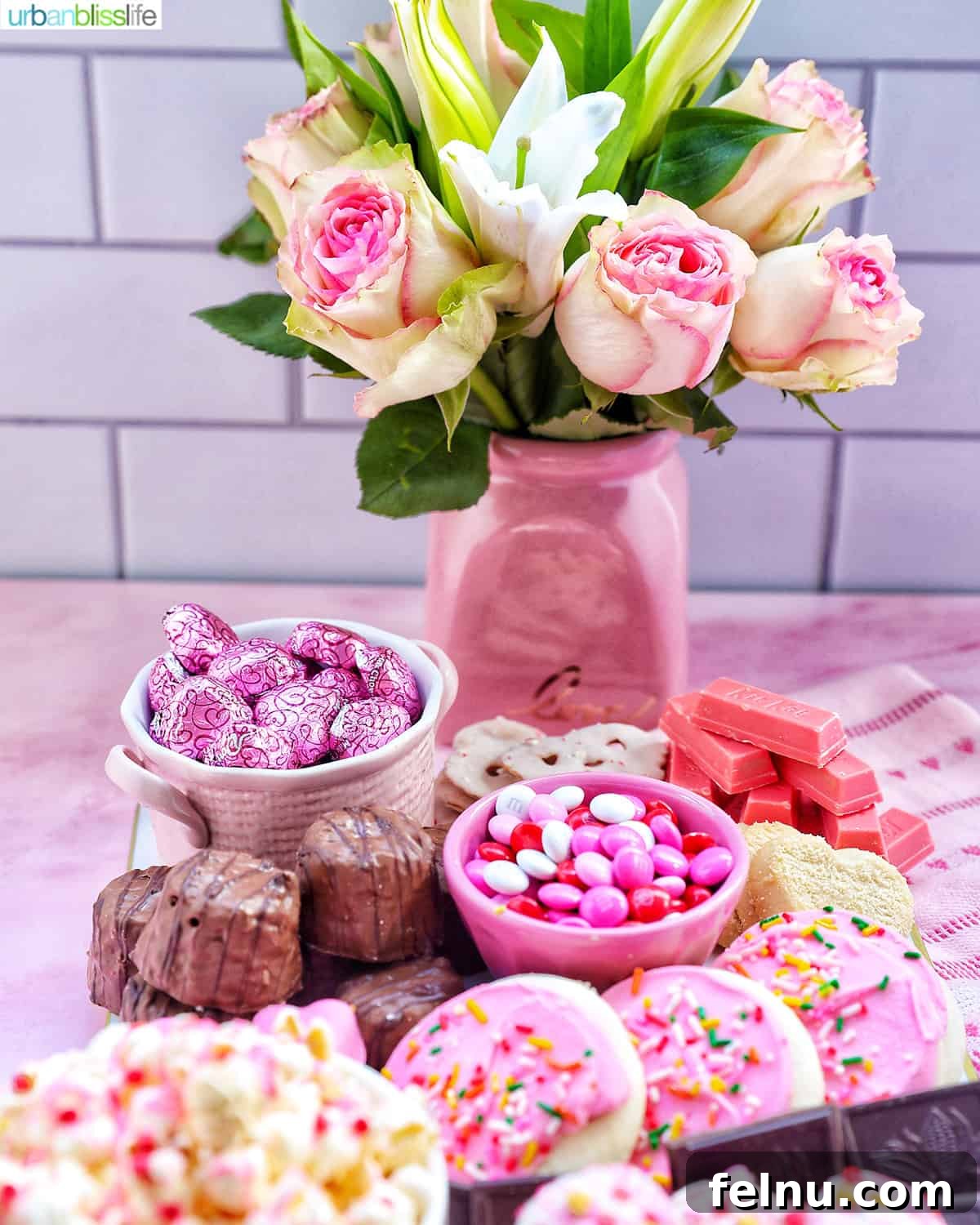 Curated Sweetscape 7 roses in a vase with a Valentine's Day Dessert Charcuterie Board