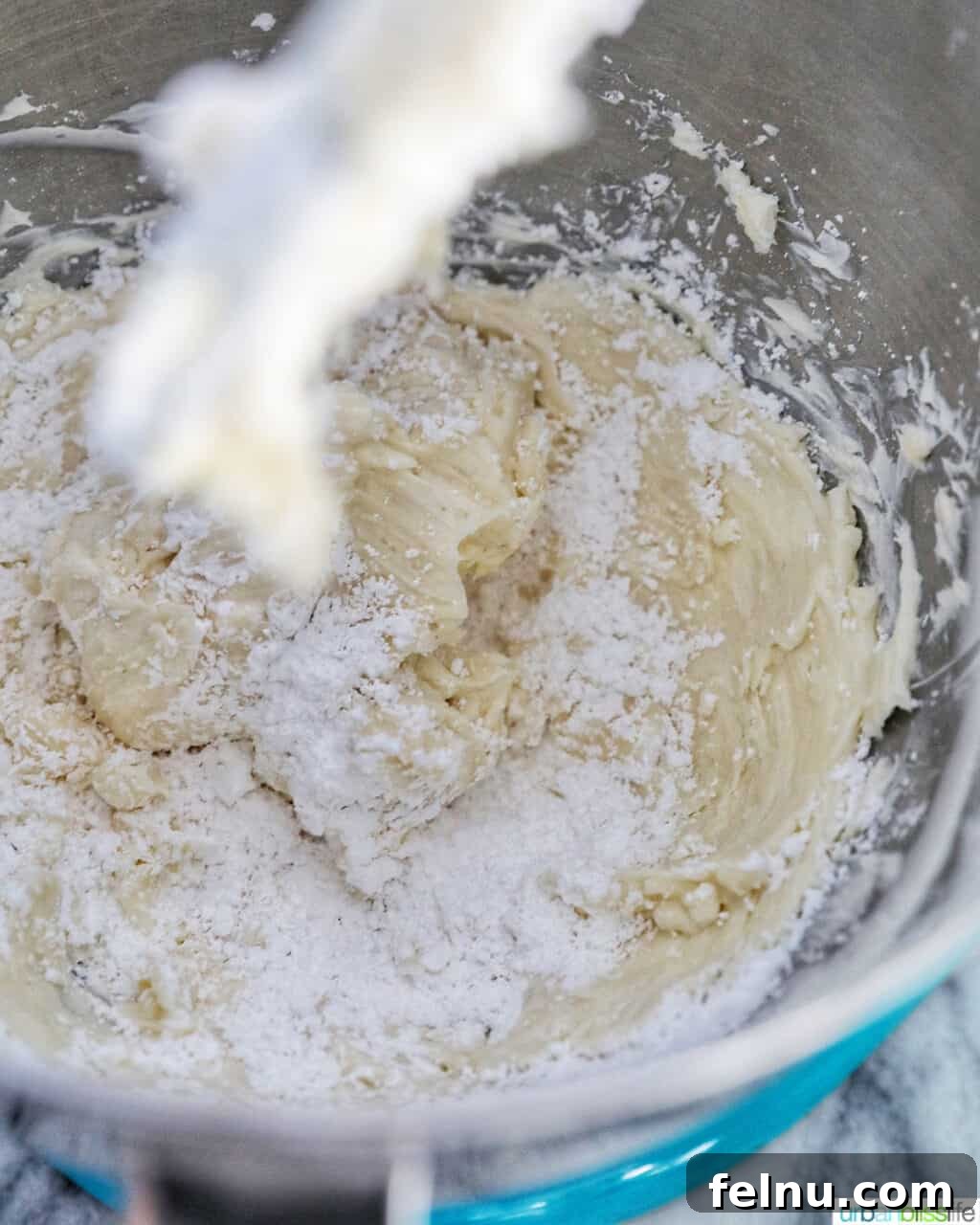 Ultimate Cream Cheese Frosting 7 Powdered sugar being gradually incorporated into the cream cheese frosting mixture