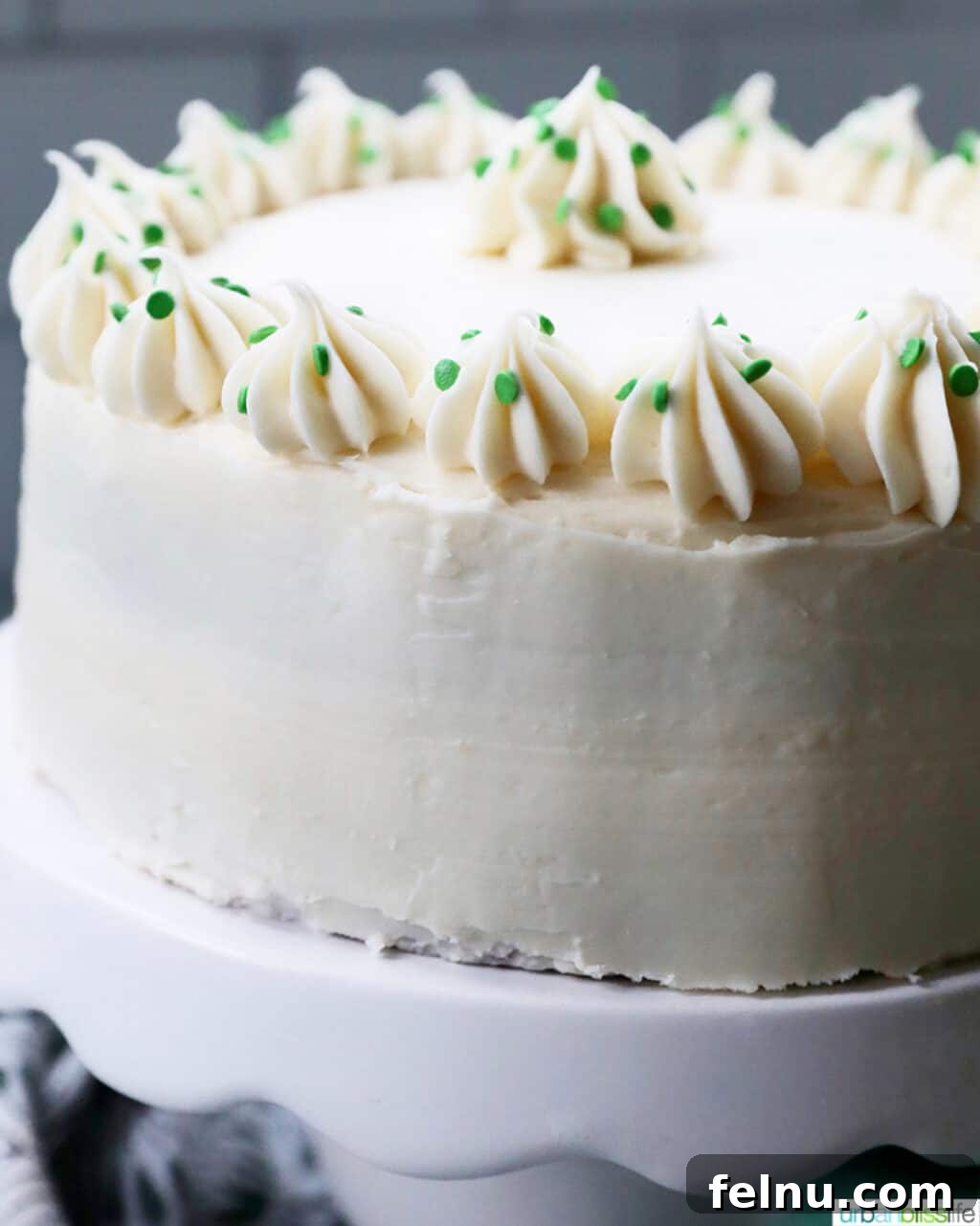 Ultimate Cream Cheese Frosting 10 Close up view of the rich, smooth cream cheese frosting on a green velvet cake
