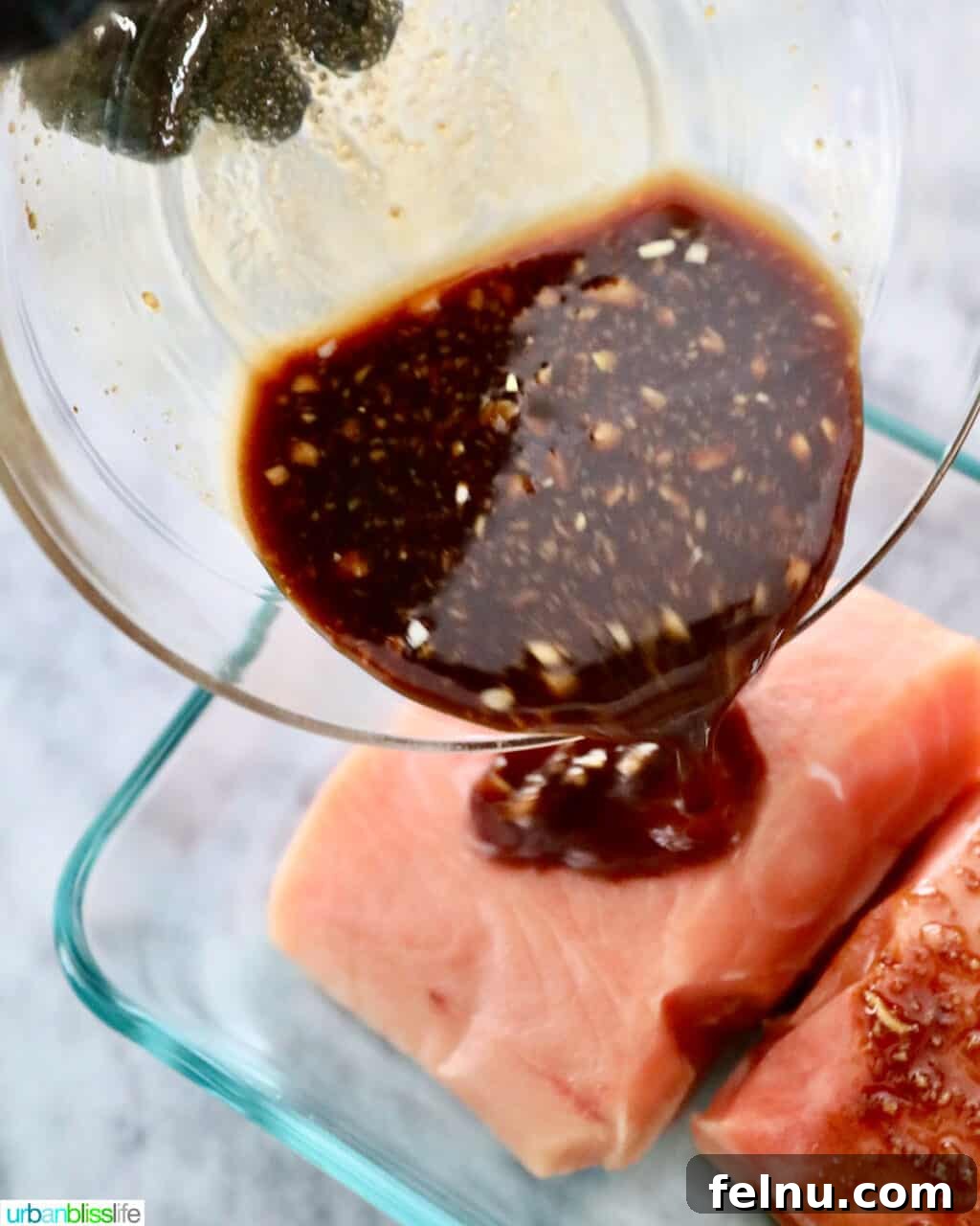 pouring marinade sauce over salmon