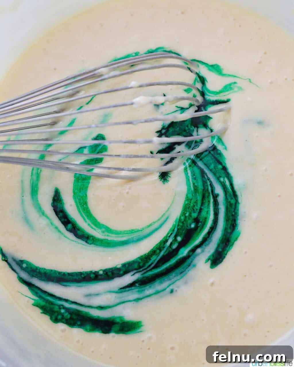 Emerald Velvet Delight with Tangy Cream Cheese 15 Green food coloring being added to the cake batter.