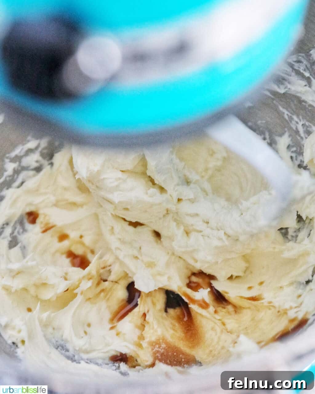 Emerald Velvet Delight with Tangy Cream Cheese 20 Vanilla extract being added to the creamed butter and cream cheese mixture.