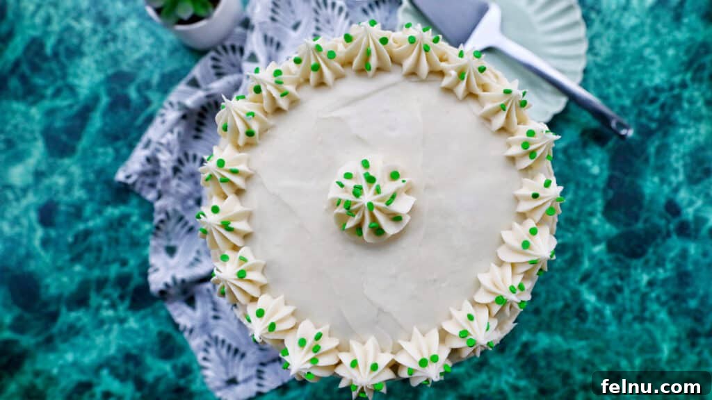 Emerald Velvet Delight with Tangy Cream Cheese 25 A stunning green velvet cake with elegant cream cheese frosting decorations.