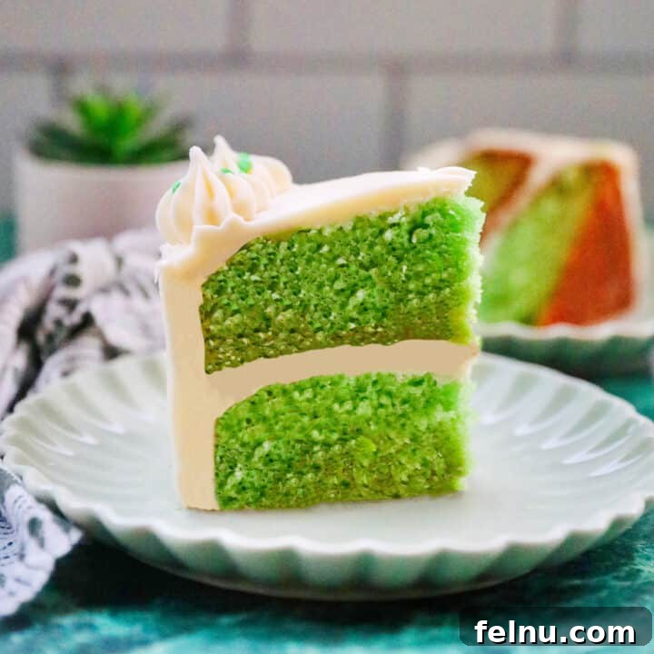 Emerald Velvet Delight with Tangy Cream Cheese 27 Slice of green velvet cake with cream cheese frosting.