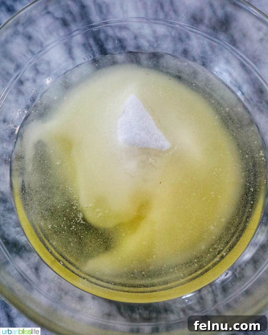 Emerald Velvet Delight with Tangy Cream Cheese 9 Granulated sugar and vegetable oil being whisked together in a bowl.