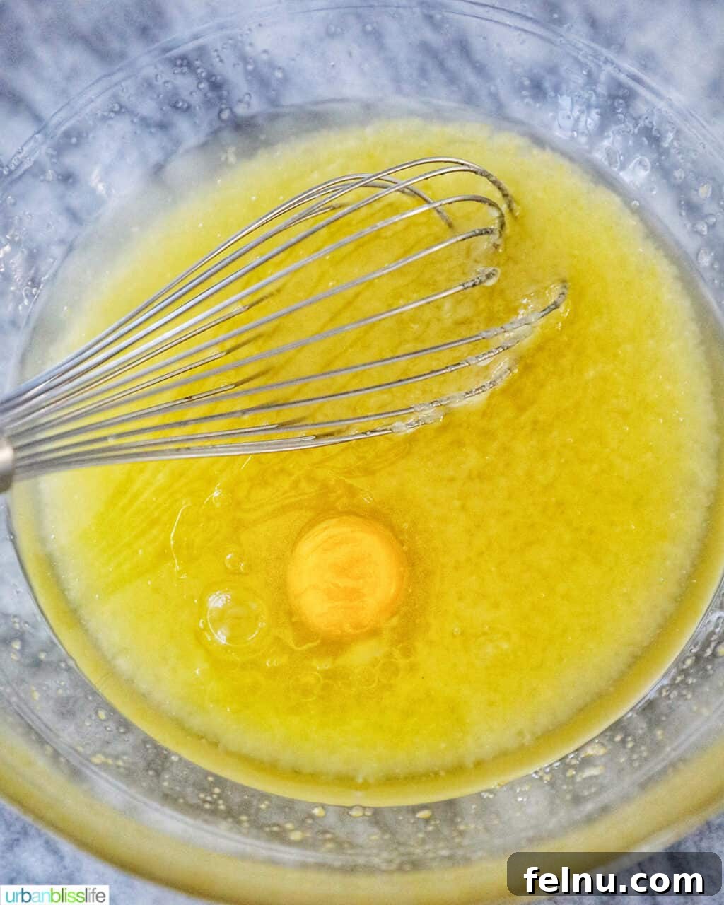 Emerald Velvet Delight with Tangy Cream Cheese 10 An egg being beaten into the sugar and oil mixture.