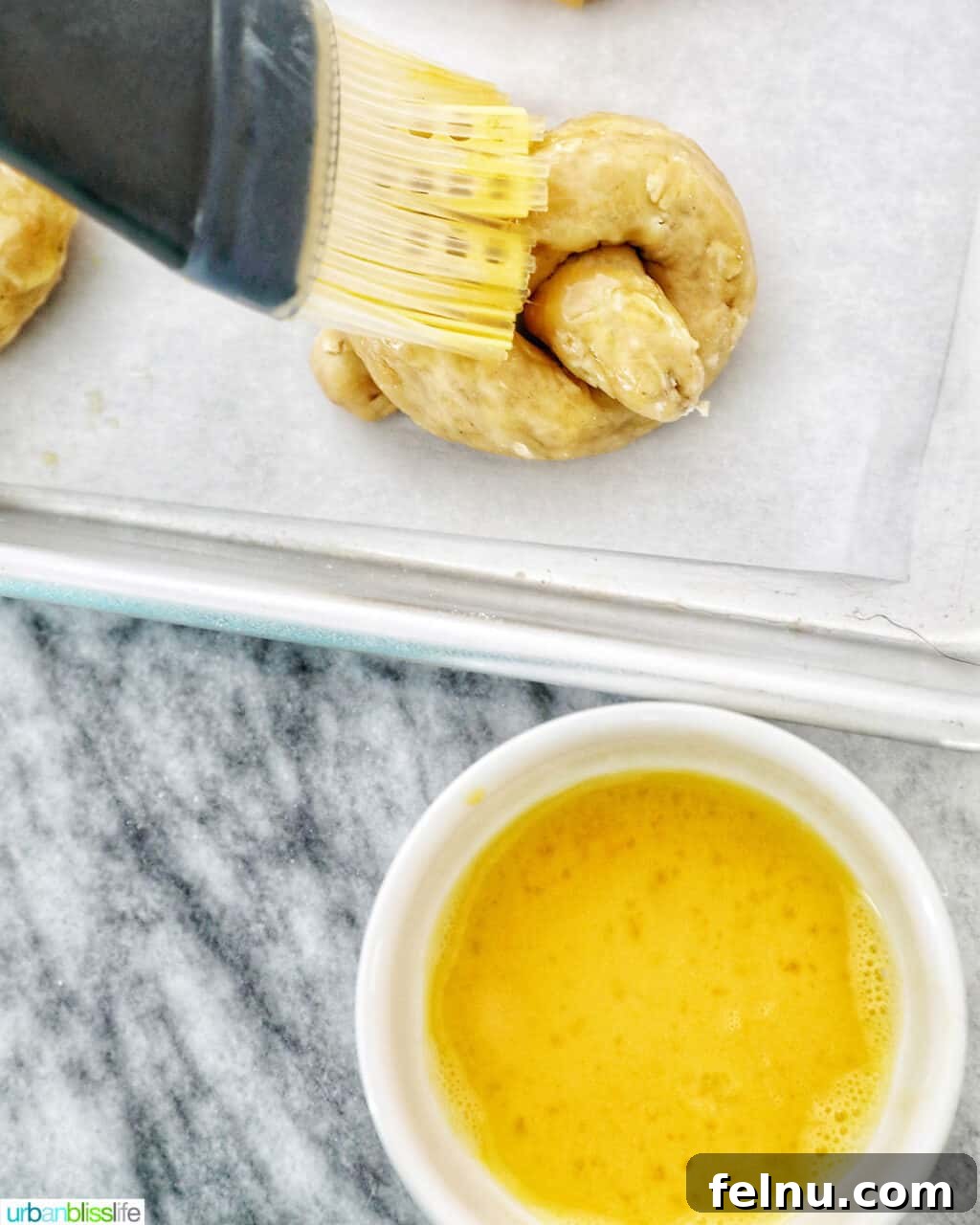 Peanut Butter Pretzel Dog Treats: A Homemade Recipe 9 adding egg wash to dog pretzels