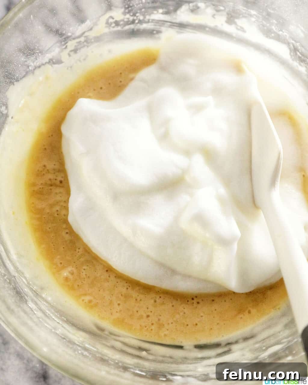 Taisan: Fluffy Filipino Chiffon Cake Perfection 17 Gently folding whipped egg whites into the cake batter with a silicone spatula