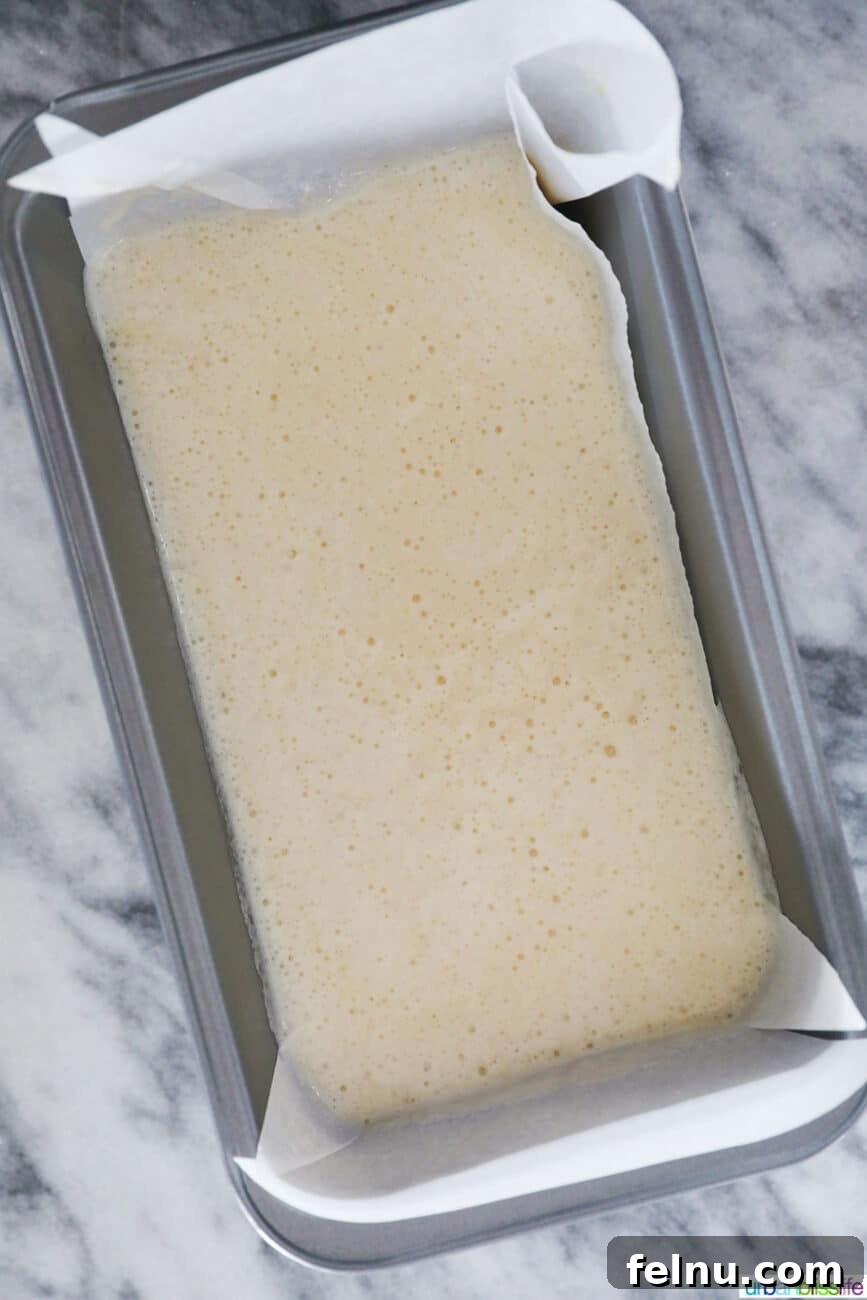 Taisan: Fluffy Filipino Chiffon Cake Perfection 19 Taisan Filipino chiffon cake batter poured into a parchment-lined loaf pan
