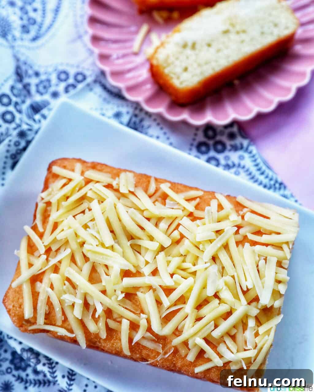 Taisan: Fluffy Filipino Chiffon Cake Perfection 3 Overhead view of a Taisan Filipino chiffon cake loaf with a single slice on a plate
