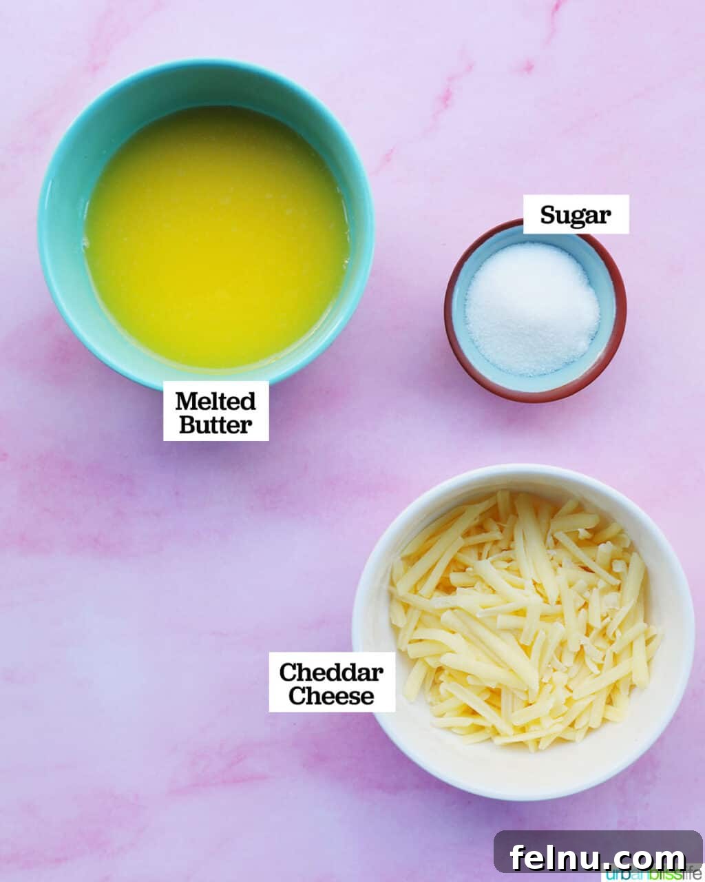Taisan: Fluffy Filipino Chiffon Cake Perfection 6 Separate bowls containing topping ingredients: melted butter, granulated sugar, and shredded cheddar cheese